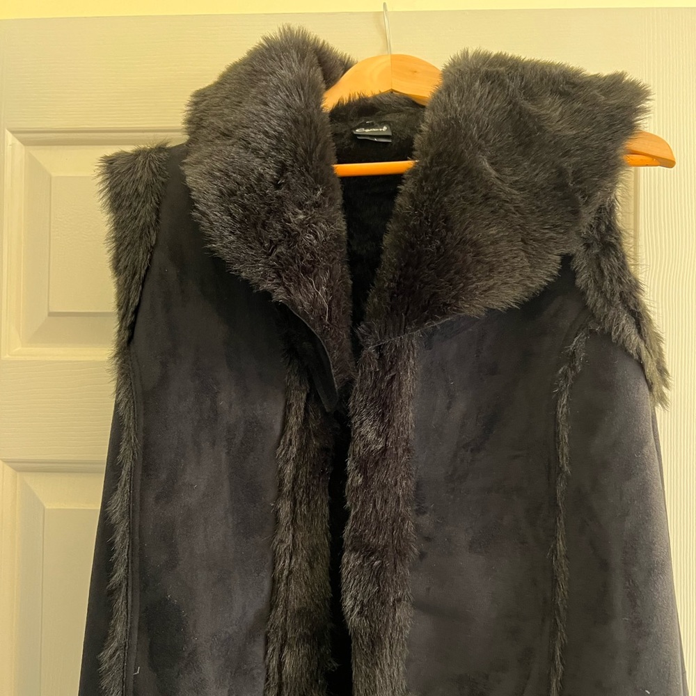 Black faux leather and fur vest. Fashionable and warm. Gently worn